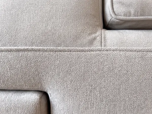 Detalle de la tela y las costuras de un sillón tapizado